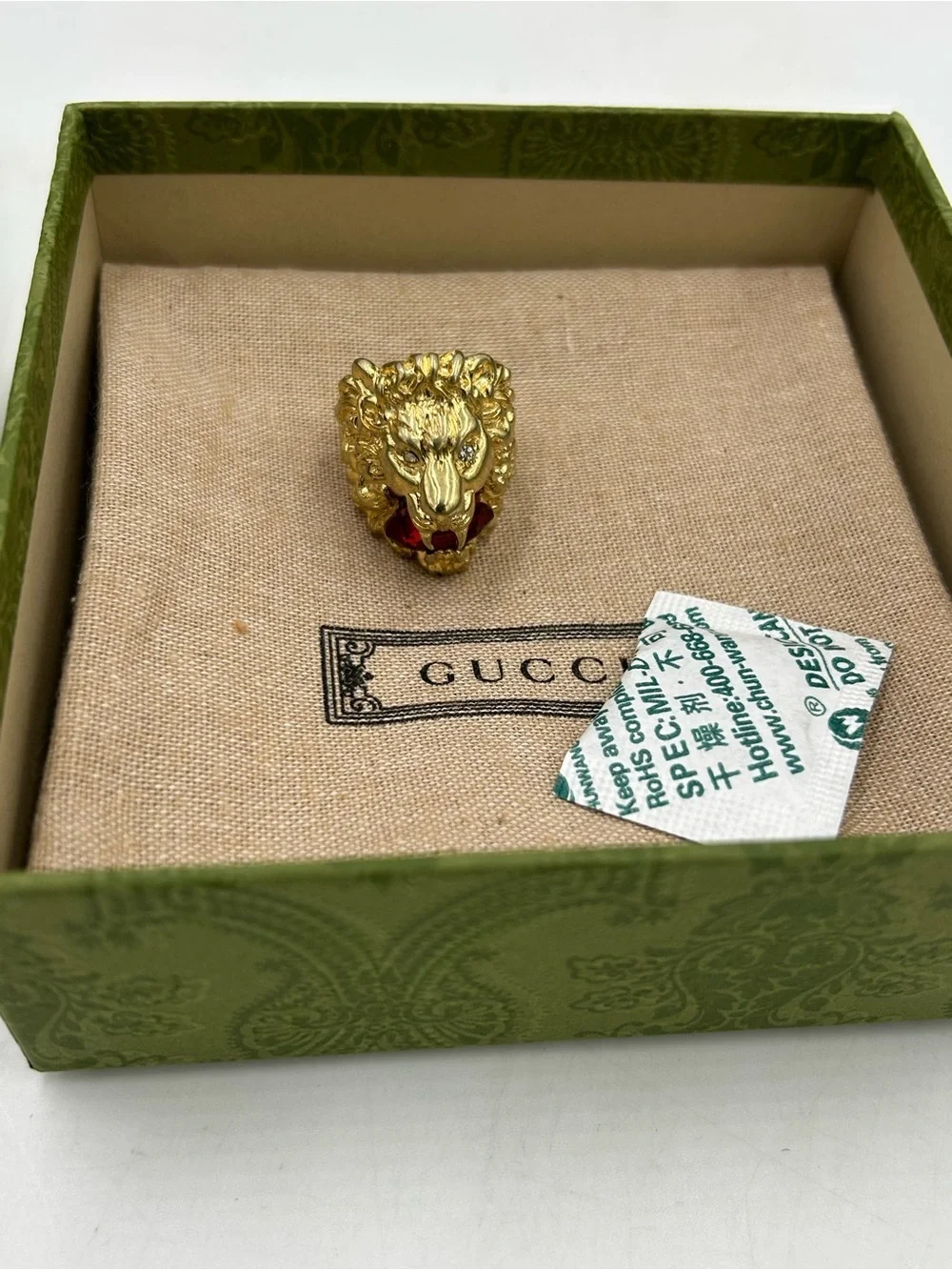 Unisex Gucci, Lionhead motif  gold tone with red crystal size 8.5 made in Italy